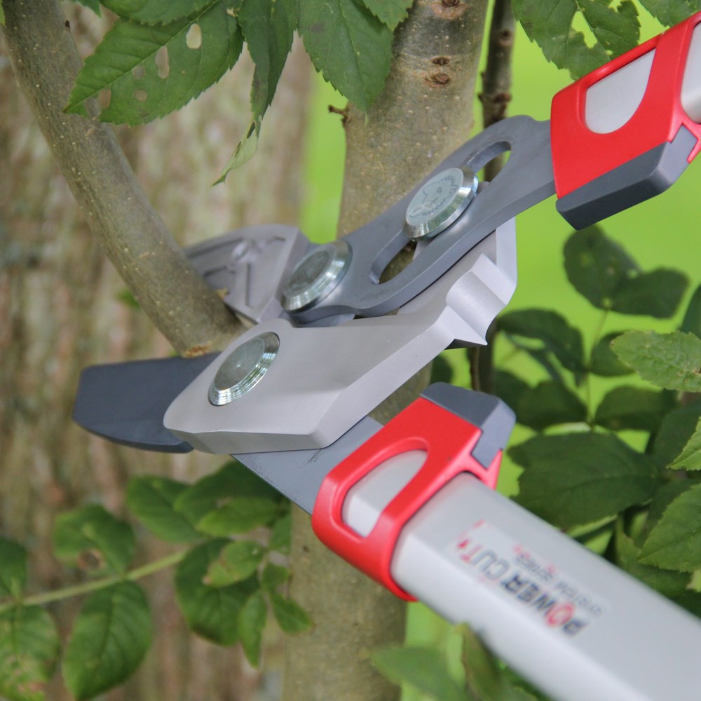close up of Non‑stick coated blades and rubber buffers on Wolf Garten RR900T cutting a branch