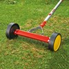 Wolf Garten urm3 modular moss remover for lawn health and aeration being shown in action on a green lawn